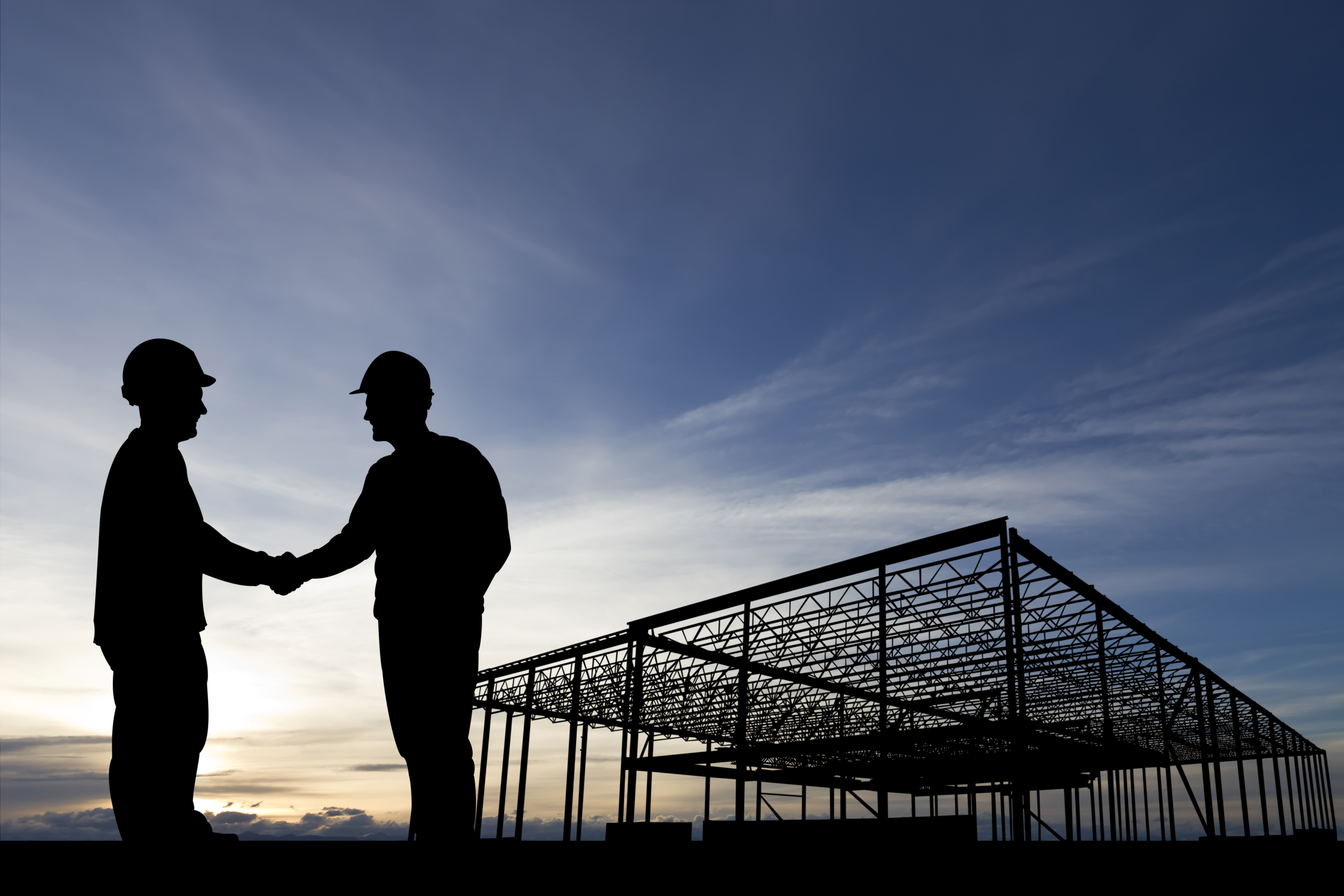 Construction site building handshake