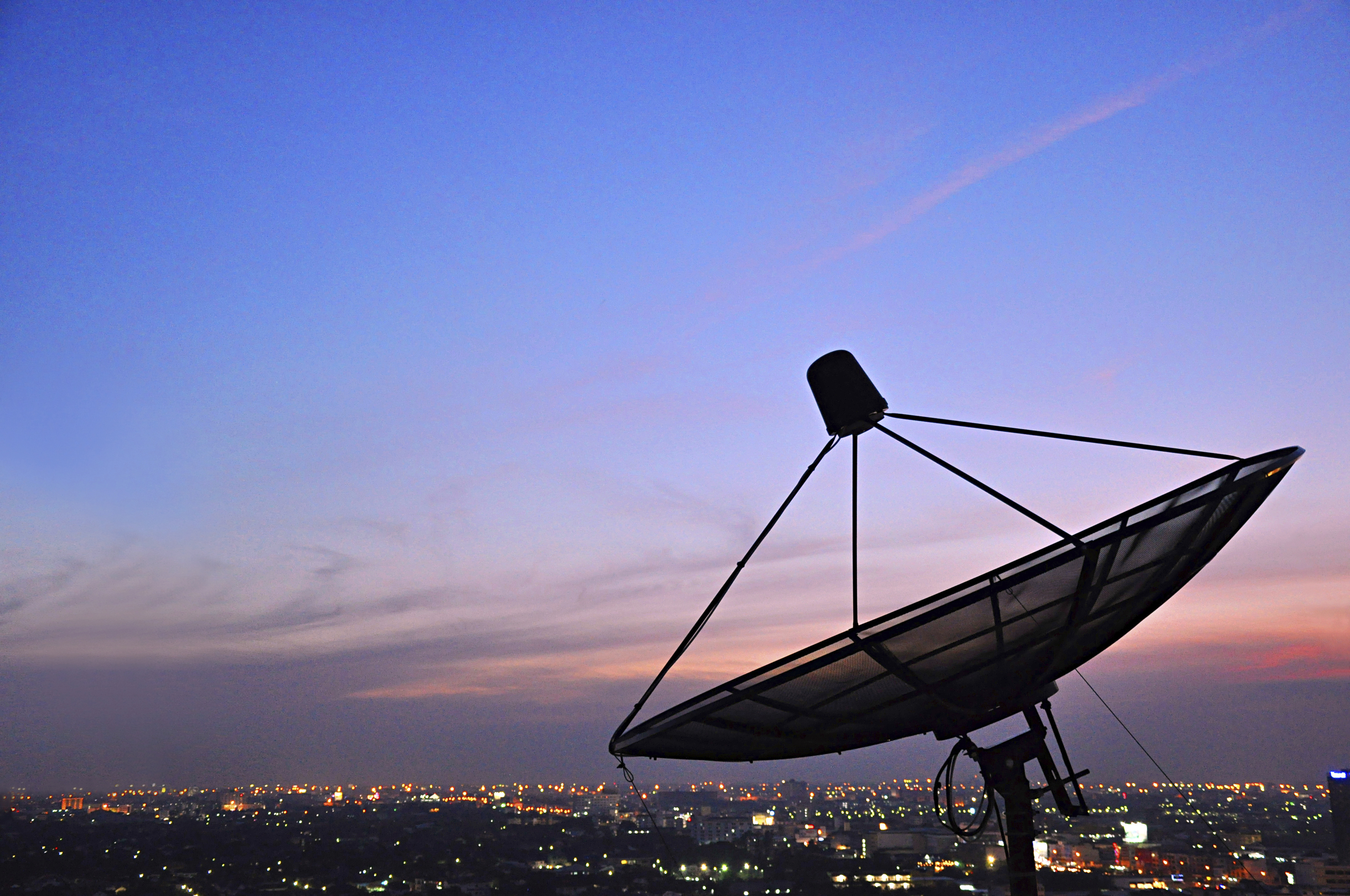 A satellite dish in twilight scene