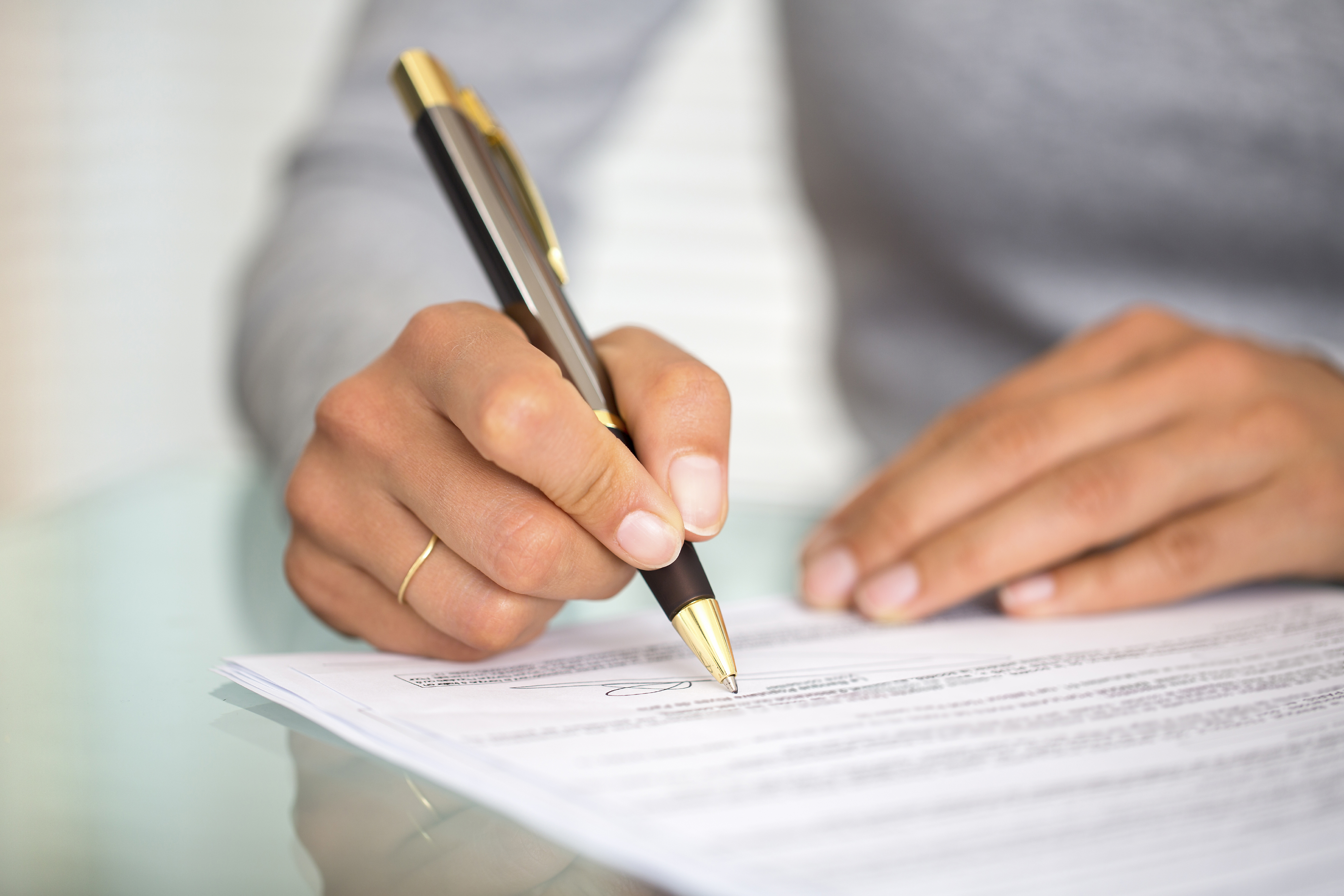 Signing contract pen hand